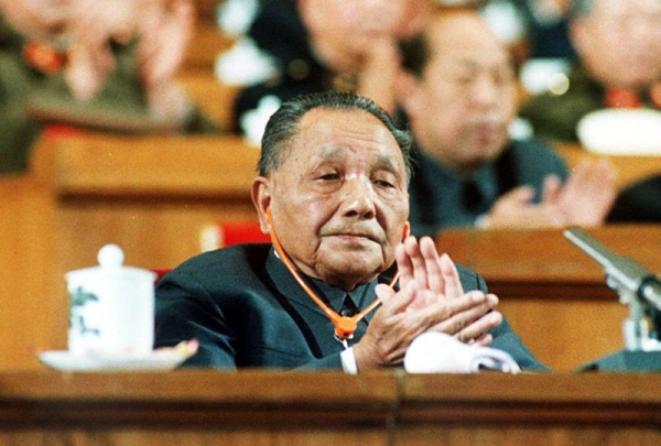 A file photo dated 25 Oct. 1987 shows China's late political patriarch Deng Xiaoping as he applauds during a session of the National People's Congress at the Great Hall of the People. (John Giannini/AFP/Getty Images)