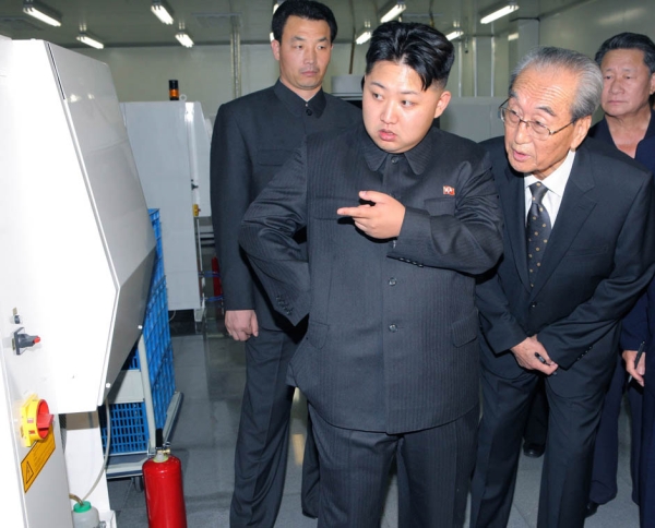 Kim Jong Un (C), dubbed the "Great Successor" to Kim Jong Il (not pictured) visits Mokran Video Company in Pyongyang in this undated picture released by the North's official KCNA news agency September 11, 2011.