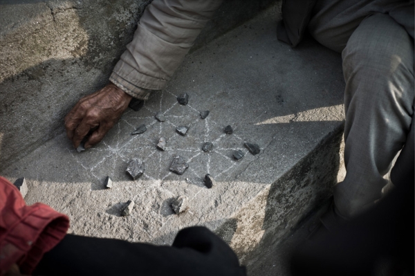 Elderly men sit and play a game of Bagh-Chal (Moving Tigers) in Chapagaon village. (Garry Waller)