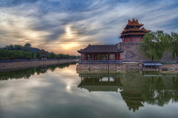 An early morning sun peeks through the clouds above the Forbidden City in Beijing on May 24, 2012. (Greg Annandale/Flickr)