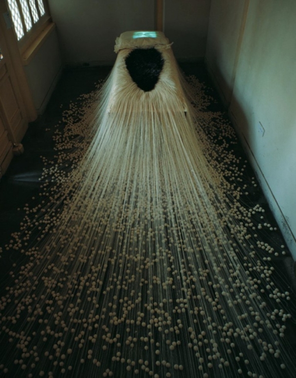 The Proliferation of Thread Winding, 1995. White cotton thread, rice paper, 20,000 needles (12 to 15 cm. in length), one bed, video, television monitor. (Lin Tianmiao)
