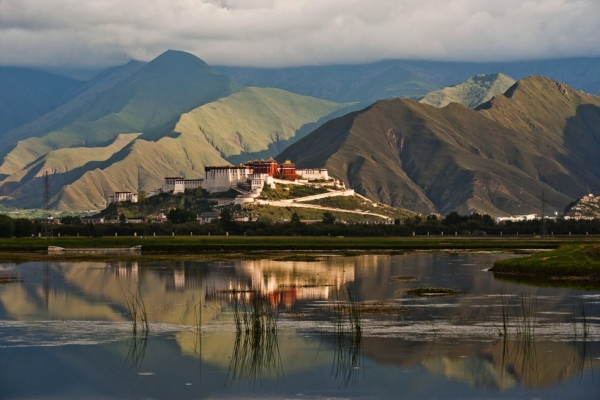 Lhasa's Potala Palace, the monastery that was home to the Dalai Lama, is among the most iconic images of Tibet. The Palace seems to float among the mountains, hovering above the marsh in the foreground. (Michael Yamashita)