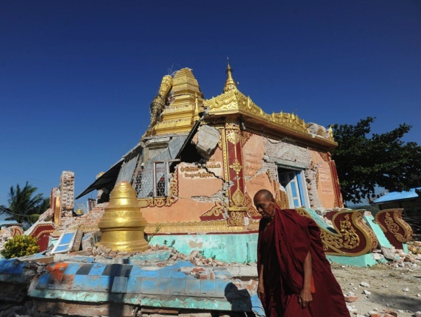 A Buddhist monk walks past a damaged pagoda in the town of  Thabaikkyin in central Myanmar on Nov. 12, 2012. (Soe Than Win/AFP/Getty Images)