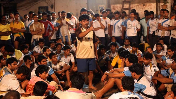 Indian coach Sandeep speaking to his team. From the movie "The Human Tower." (Goldcrest Films International)
