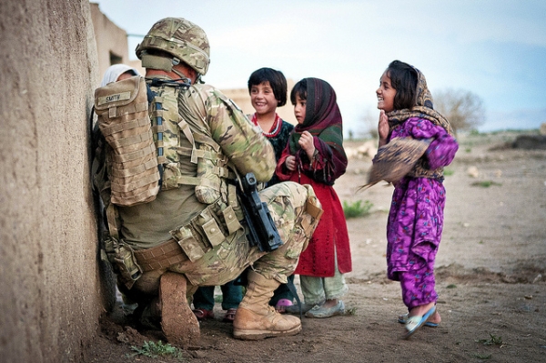 U.S. Army Sgt. Joshua Smith talks to group of Afghan children during a combined patrol clearing operation in Afghanistan's Ghazni province on April 28, 2012. (United States Army/Flickr)