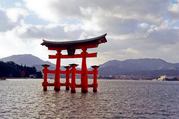 The vibrant red Torii gate stands alone in the water in Miyajima, Japan on January 23, 2013. (PatH3220/Flickr)