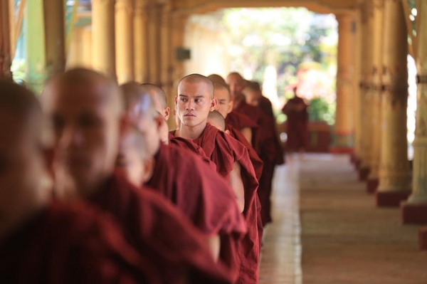 Monks of Kha Khat Wain Kyaung Monastery stand in line in Bago, Myanmar on February 19, 2013. (hans a rosbach/Flickr)