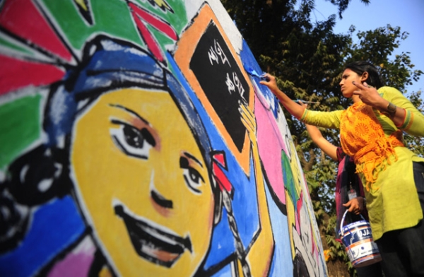 A Bangladeshi art student paints on a wall in front of the Shahid Minar in preparation for Language Martyrs Day and International Mother Language Day in Dhaka on Feb. 20, 2012. (Munir Uz Zaman/AFP/Getty Images)