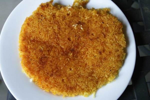 Tahdig, the buttery burnt layer of rice that is a Persian delicacy.