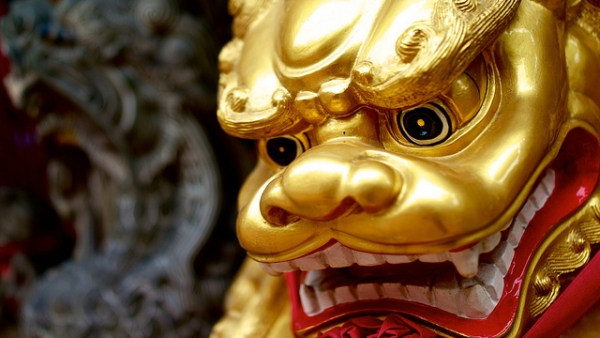 A Komainu or Lion Dog guards the entrance outside a Buddhist temple in Singapore on April 14, 2013. (Aural Asia/Flickr)