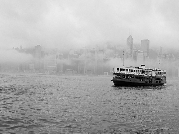 The Star Ferry sails out of the fog covering the Hong Kong Central skyline on April 21, 2013. (Cody Wms/Flickr)