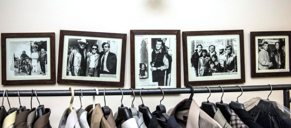 Framed photographs lining the walls of Chaudry's home testify to his years spent dressing VIPs like Roger Moore (in "Octopussy," center photo). (Saad Sarfraz Sheikh)