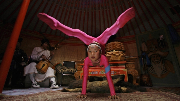 A 10-year-old Mongolian acrobat performs in the capital Ulaanbaatar during the annual Naadam Festival in July 2006. (Peter Parks/AFP/Getty Images)