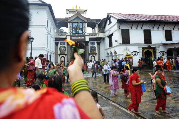 A Nepalese Hindu holds up offerings in honor of Lord Shiva at the Pashupatinath Temple in Kathmandu on July 22, 2013. (Prakash Mathema/AFP/Getty Images)