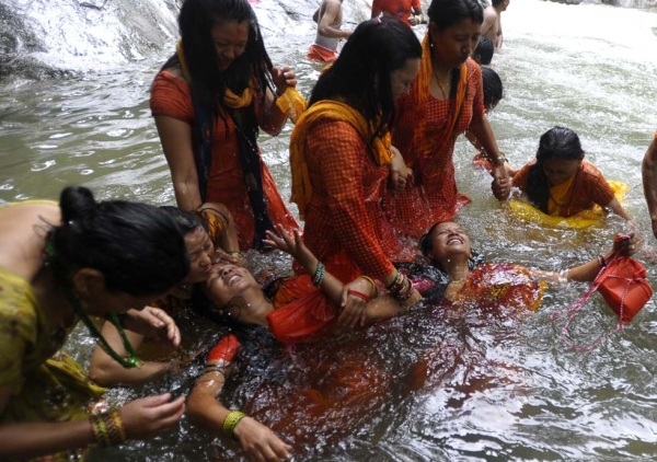 Nepalese Hindu devotees bathe in the Bagmati River for Shravan festivities before heading toward the Pashupatinath Temple in Sundarijal on the outskirts of Kathmandu on July 29, 2013. (Prakash Mathema/AFP/Getty Images)