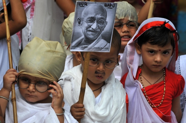 Schoolchildren dressed as Mahatma Gandhi and his wife Kasturba Gandhi take part in rehearsals for Gandhi Jayanti (birthday) celebrations in Siliguri, India on September 28, 2012. (Diptendu Dutta/AFP/GettyImages)