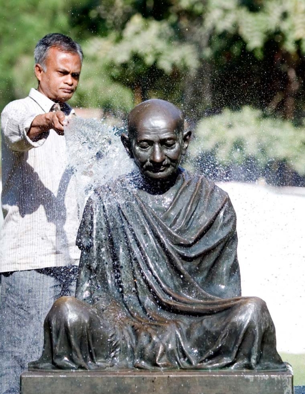 An Indian caretaker washes a statue of Mahatma Gandhi installed at the Gandhi Ashram in Ahmedabad, India on January 29, 2009. (Sam Panthaky/AFP/Getty Images)