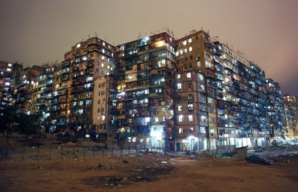 Lights illuminate the Kowloon Walled City at night. Originally a Chinese fort, the Walled City became a crowded residential dwelling after the British occupation of Hong Kong, and was ultimately demolished in 1993. Photo: Greg Girard