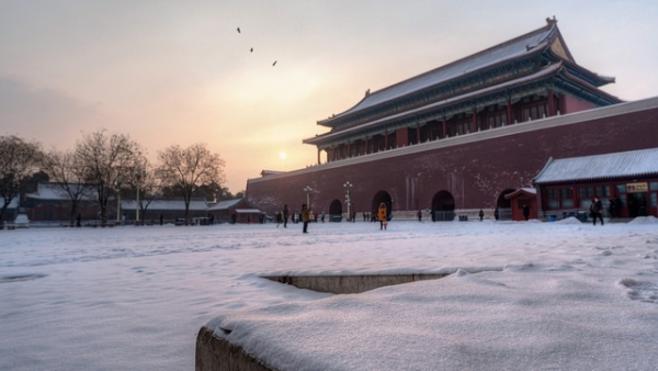 On a snowy day tourists stop for photos at the Forbidden City in Beijing, China on February 8, 2014. (Nathan Quarles/Flickr)