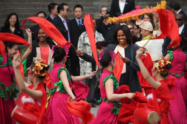 U.S. First Lady Michelle Obama and her daughter Sasha enjoy a traditional dance performance during their visit the Xi'an City Wall in Xi'an on March 24, 2014. (Feng Li/Getty Images) 