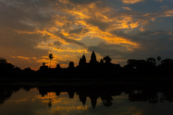 The sky is streaked in golden rays as the sun rises over Angkor Wat, Cambodia on April 4, 2014. (Jared Smith/Flickr)