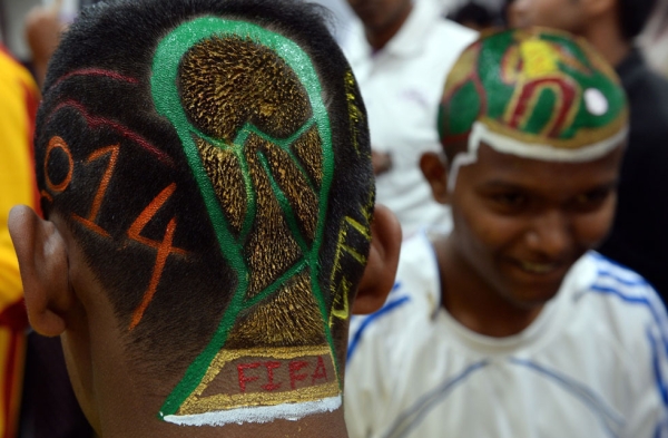 India football enthusiasts Nilesh Kadam (L) and Abhijit Chavan (R) have World Cup-inspired scenes and the trophy logo painted into haircuts at a salon in Mumbai on June 9, 2014. (Indranil Mukherjee/AFP/Getty Images)