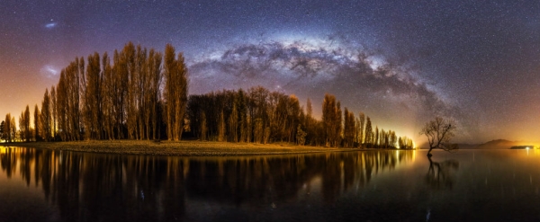 Wanaka Way. The Milky Way arches over New Zealand's Lake Wanaka and the "Lone Tree" of Wanaka. © Mike MacKinven, New Zealand, Shortlist, Panoramic, Open, 2015 Sony World Photography Awards.