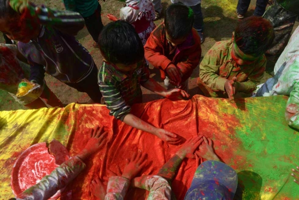 Children play with gulal as they celebrate Holi in Siliguri, India on March 4, 2015. (Diptendu Dutta/AFP/Getty Images)