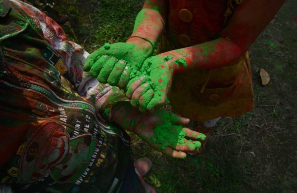 Children celebrate Holi in Siliguri, India on March 4, 2015 with fists full of colored powder known as gulal. (Diptendu Dutta/AFP/Getty Images)