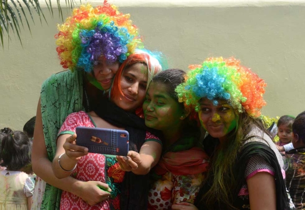 A group of women pose for a photograph after playing with gulal as they celebrate Holi in Siliguri, India on March 4, 2015. (Diptendu Dutta/AFP/Getty Images)