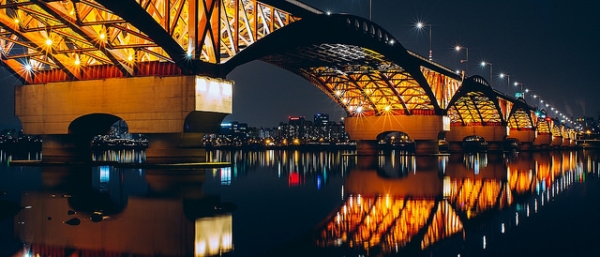 Seongsan Bridge casts a vibrant reflection on the Han River in Seoul, South Korea on February 28, 2015. (H.B. Kang/Flickr)