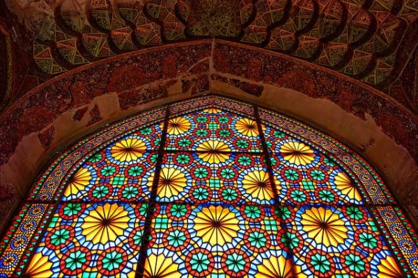 Sunshine lights up an intricate multi-colored stained glass window in Iran on April 29, 2015. (Luca Cerabona/Flickr)