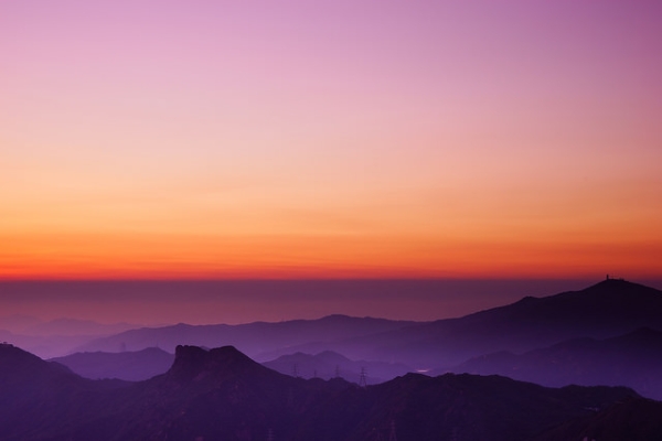 Mountains near and far appear in different shades of purple as the sun sets on April 5, 2015 in Hong Kong. (tommy@chau/Flickr)