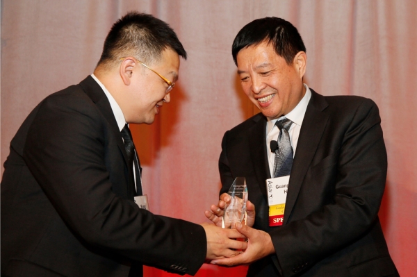 From left, President Gao Yang of Yucheng Zhongluan Investment Group presents Hou Guangmin, Beijing Film Academy, with the Film Education Legacy Award during the 2015 Asia Society U.S.-China Film Summit and Gala held at the Dorthy Chandler Pavilion on Thursday, November 5, 2015, in Los Angeles, Calif. (Ryan Miller/Capture Imaging)