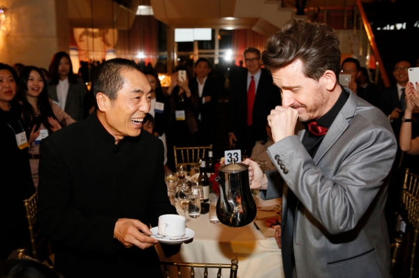 From right, emcee Jeff Locker fulfills a dream to pour Zhang Yimou, director and Lifetime Achievement Award winner, a cup of coffee during the 2015 Asia Society U.S.-China Film Summit and Gala held at the Dorthy Chandler Pavilion on Thursday, November 5, 2015, in Los Angeles, Calif. (Ryan Miller/Capture Imaging)