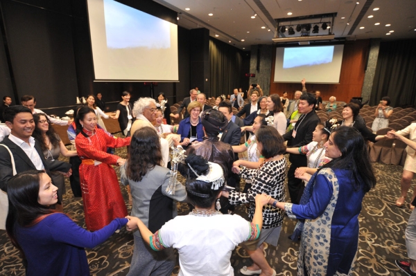 Performers from the Dimen Dong Folk Chorus lead summit participants in a traditional circle dance. (Elvis Ho)