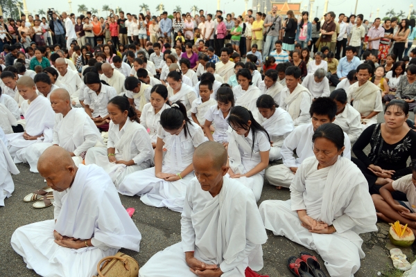 Cambodian monks, nuns and other citizens pray in front of the Royal Palace in Phnom Penh on October 15, 2012 in remembrance of their former king. Sihanouk's passing overnight fell poignantly during the solemn festival of the dead. (Tang Chhin Sothy/AFP/Getty Images)