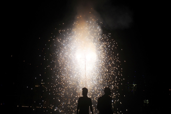 Revelers watch fireworks at a Kolkata park during Diwali on November 13, 2012. (Dibyangshu Sarkar/AFP/Getty Images)