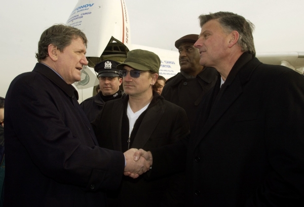 Holbrooke was active in international causes even when not serving in government. Here he meets with musician Bono (C) and  President of Samaratin&apos;s Purse Franklin Graham (R) at JFK International airport in New York City prior to the &quot;Christmas Airlift to Young HIV/Aids Victims&quot; on Dec. 10, 2002.  (Mark Mainz/Getty Images)