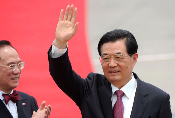 Chinese President Hu Jintao (R) waves to the press as Hong Kong Chief Executive Donald Tsang claps after arriving at Hong Kong's International airport on June 29, 2012. (Dale de la Rey/AFP/GettyImages)