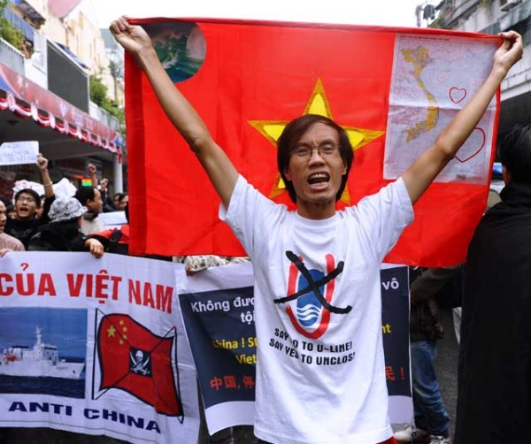Amid heightened territorial tensions over the South China Sea, protestors shout anti-China slogans and hold banners as they march towards the Chinese embassy in downtown Hanoi on Dec. 9, 2012. (Hoang Dinh Nam/AFP/Getty Images) 