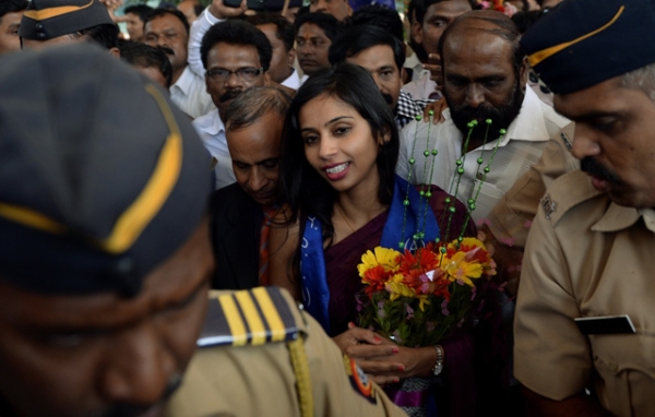 Indian diplomat Devyani Khobragade (CR), accompanied by her father Uttam Khobragade (CL) and surrounded by supporters and policemen, arrives at the domestic airport in Mumbai on January 14, 2014. (Punit Paranjpep/AFP/Getty Images)