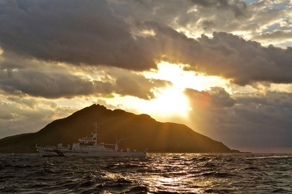 A Japanese Coast Guard boat passes by Uotsuri, the largest island in the Senkaku/Diaoyu chain, in October 2012. (Al Jazeera English/Flickr) 