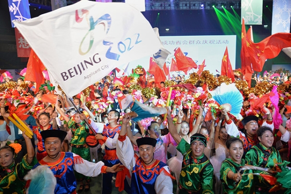 Chinese people wearing traditional costumes gather to celebrate as Beijing is announced as the host city for the 2022 Winter Olympic Games, in Shijiazhuang, the capital of northern China's Hebei province on July 31, 2015. (STR/AFP/Getty Images)