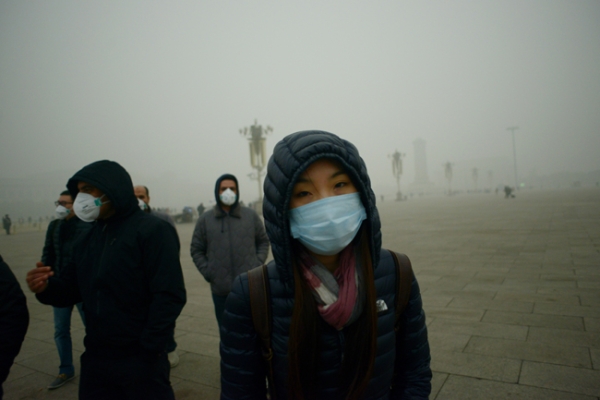 Visitors wearing face masks brave air pollution in Beijing's Tiananmen Square. (Wang Zhen/AFP/Getty Images)