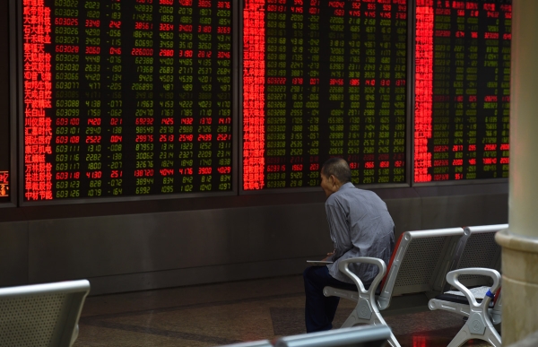 An investor watches stock price movements on a screen at a securities company in Beijing. (Greg Baker/AFP/Getty Images)