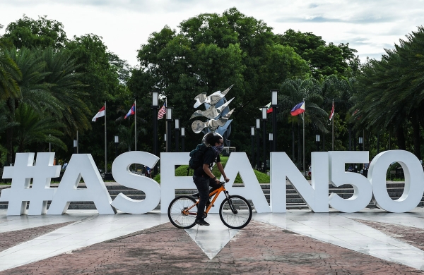 A man rides his bicycle in front of the ASEAN logo near the venue for the Association of Southeast Asia Nations (ASEAN) Regional Forum (ARF) meeting in Manila on August 4, 2017. (Mohd Rasfan/AFP/Getty Images)