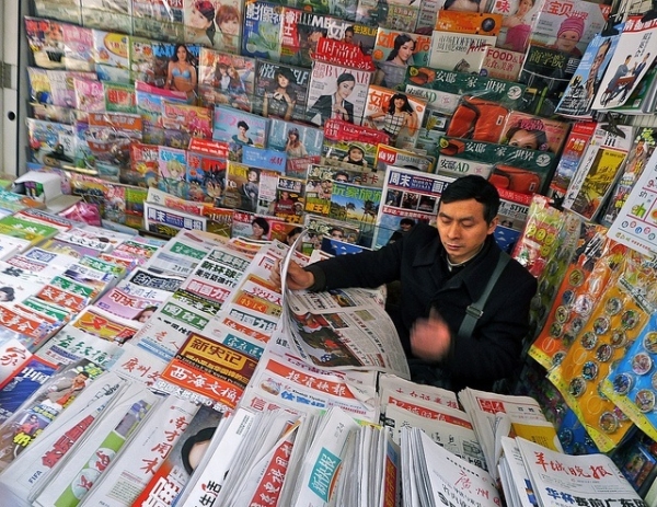Catching up with the morning's headlines in a stall in Guangzhou, China on March 24, 2012. (r s gould/Flickr)