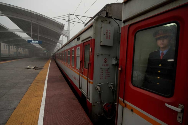 A conductor stands aboard a train carrying Lunar New Year travellers bound for Chongqing at the Baoding railway station in Hebei Province, south of Beijing on January 31, 2013. (Ed Jones/AFP/Getty Images)
