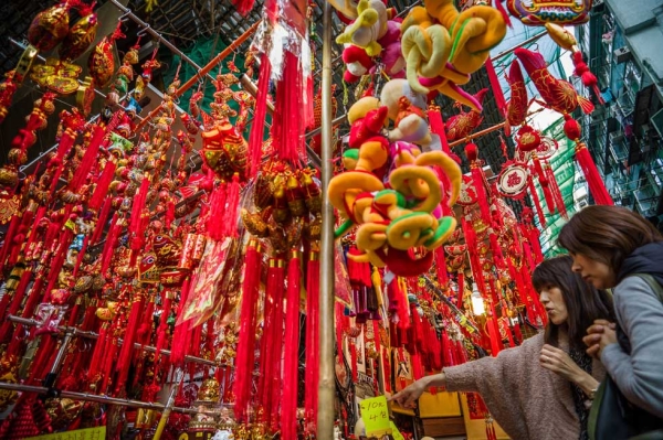 Two women look at a display of Lunar New Year items for sale at a street market in Hong Kong on January 31, 2013. (Philippe Lopez/AFP/Getty Images)